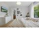 Comfortable bedroom features neutral decor and a view into the adjacent bathroom at 14467 Prunningwood Pl, Winter Garden, FL 34787