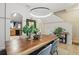 Bright dining area features wood table, modern light fixture, and stylish decor at 14467 Prunningwood Pl, Winter Garden, FL 34787