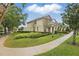 Well-manicured lawn with walkway to these charming townhomes under a beautiful sky at 14467 Prunningwood Pl, Winter Garden, FL 34787