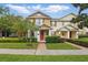 Charming two-story townhome with a brick walkway and a beautifully landscaped front yard at 14467 Prunningwood Pl, Winter Garden, FL 34787