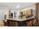 Well-equipped kitchen featuring oak cabinets, modern appliances, and a breakfast bar at 14467 Prunningwood Pl, Winter Garden, FL 34787
