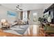 Living room with a white couch, modern area rug, and access to the backyard at 14467 Prunningwood Pl, Winter Garden, FL 34787