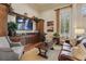 Elegant living room with a large TV, hardwood floors, and designer furniture at 14467 Prunningwood Pl, Winter Garden, FL 34787