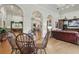 Elegant lounge features hardwood floors, a comfortable seating area with a large TV, and decorative archways at 14467 Prunningwood Pl, Winter Garden, FL 34787