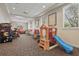 Fun playroom with a Pac-Personal arcade game, a slide, and a colorful play structure at 14467 Prunningwood Pl, Winter Garden, FL 34787