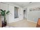 Hallway features a laundry closet, plant, and artwork at 14467 Prunningwood Pl, Winter Garden, FL 34787