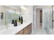 Modern bathroom featuring dual sinks, quartz counters, and walk-in glass shower at 15343 Rising View Dr, Montverde, FL 34756
