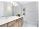 Modern bathroom featuring double sinks, wooden cabinetry, and stylish fixtures, creating a clean and functional space at 15343 Rising View Dr, Montverde, FL 34756