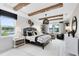 Bright bedroom with wooden ceiling beams, shiplap accent wall, and a large window at 15343 Rising View Dr, Montverde, FL 34756