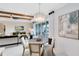 Elegant dining area with a chandelier, and sliders to the outdoors, adjacent to the open-concept living room at 15343 Rising View Dr, Montverde, FL 34756
