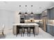 Modern kitchen with a spacious island, sleek grey cabinets, and stainless steel appliances at 15343 Rising View Dr, Montverde, FL 34756