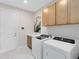 The functional laundry room features modern appliances, ample cabinet space, and a utility sink at 15343 Rising View Dr, Montverde, FL 34756