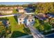 Aerial view of a two-story home in a residential neighborhood featuring mature trees and green lawns at 181 Zachary Wade St, Winter Garden, FL 34787