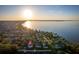 Expansive aerial view capturing sunset over lakeside community homes, featuring stunning water views at 181 Zachary Wade St, Winter Garden, FL 34787