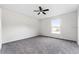 Bedroom featuring neutral walls, gray carpet, ceiling fan and a window with natural light at 181 Zachary Wade St, Winter Garden, FL 34787
