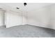 Spacious carpeted bedroom with closet and view into the hallway at 181 Zachary Wade St, Winter Garden, FL 34787