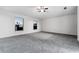 Large bedroom with carpeting, two windows and a ceiling fan at 181 Zachary Wade St, Winter Garden, FL 34787