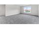 Spacious bedroom with a large window providing ample natural light and neutral carpeting at 181 Zachary Wade St, Winter Garden, FL 34787