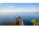 Aerial view of a covered boat dock on calm, inviting lake with blue sky at 181 Zachary Wade St, Winter Garden, FL 34787