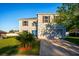 Well-maintained two-story home featuring a manicured lawn, blue front door and an attached two-car garage at 181 Zachary Wade St, Winter Garden, FL 34787