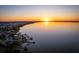 Tranquil aerial scene of lake at sunset, featuring waterfront houses and picturesque landscape at 181 Zachary Wade St, Winter Garden, FL 34787