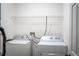 Bright laundry room with washer, dryer, and storage shelf at 181 Zachary Wade St, Winter Garden, FL 34787