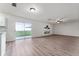 Open-concept living space featuring hardwood floors, a ceiling fan, and sliding glass doors to backyard at 181 Zachary Wade St, Winter Garden, FL 34787
