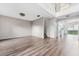 Open living room with wood floors and access to the kitchen and backyard at 181 Zachary Wade St, Winter Garden, FL 34787