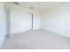 Neat bedroom with carpet and white walls. The room has a white door and plenty of space at 1811 Silverbell Loop, Haines City, FL 33844