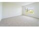Bright and airy bedroom with neutral carpet and a large window offering ample natural light at 1811 Silverbell Loop, Haines City, FL 33844