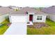 Charming single-story home with gray exterior, white garage door, and a neatly landscaped front yard at 1811 Silverbell Loop, Haines City, FL 33844