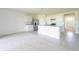 Open floor plan kitchen with white cabinets, granite countertops and stainless steel appliances at 1811 Silverbell Loop, Haines City, FL 33844