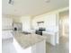 Bright kitchen with stainless steel appliances, an island, and white cabinets at 1811 Silverbell Loop, Haines City, FL 33844