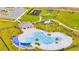 Aerial view of the community pool and recreation area, with seating, playground, and picnic shelter at 1811 Silverbell Loop, Haines City, FL 33844