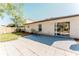 Exterior view of the home showcasing a patio area and a spacious backyard with a wooden fence at 1832 Corner Meadow Cir, Orlando, FL 32820