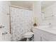 Bathroom featuring a shower-tub combo, toilet, and a white vanity with a decorative mirror at 1832 Corner Meadow Cir, Orlando, FL 32820