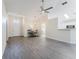 Bright and airy living room featuring modern light fixtures, neutral walls, and wood-look flooring at 1832 Corner Meadow Cir, Orlando, FL 32820