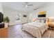 Bright main bedroom with wood floors, ceiling fan and ensuite bath at 1832 Corner Meadow Cir, Orlando, FL 32820