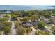 Aerial view of the property showcasing the lake, surrounding neighborhood, and lush greenery at 2011 Oakbend Dr, Eustis, FL 32726