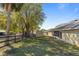 Backyard with a lush lawn, mature trees and a small shed at 2011 Oakbend Dr, Eustis, FL 32726