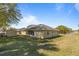 Large grassy backyard with a storage shed provides ample space for outdoor activities at 2011 Oakbend Dr, Eustis, FL 32726