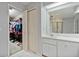 Bright bathroom featuring a marble vanity and a large mirror, offering a spa-like ambiance with closet in view at 2011 Oakbend Dr, Eustis, FL 32726