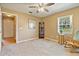 Carpeted Bedroom with a corner curio cabinet, a wooden rocking chair, and a bright window at 2011 Oakbend Dr, Eustis, FL 32726