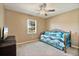 Neutral toned bedroom with carpeted floors, a ceiling fan, and a brightly lit window at 2011 Oakbend Dr, Eustis, FL 32726