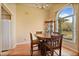Cozy dining area with wood table, chairs, chandelier, and large window, perfect for Gathering meals at 2011 Oakbend Dr, Eustis, FL 32726