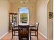 Lovely dining room with a round wood table, chair, chandelier, and large window at 2011 Oakbend Dr, Eustis, FL 32726