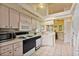 Bright kitchen featuring white appliances, cabinetry, and countertops, with access to a breakfast nook at 2011 Oakbend Dr, Eustis, FL 32726