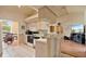 Bright kitchen featuring white cabinets and appliances, with an open view to the Gathering room at 2011 Oakbend Dr, Eustis, FL 32726