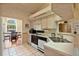 Bright kitchen featuring white cabinets and appliances, with an open view to the breakfast nook at 2011 Oakbend Dr, Eustis, FL 32726