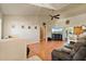 Open-concept living room with vaulted ceilings, wood floors, and sliding glass doors for natural light at 2011 Oakbend Dr, Eustis, FL 32726